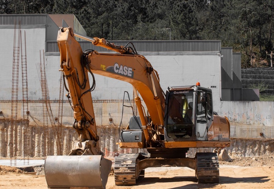 Graded soil sloping away from a house foundation toward a shaped swale